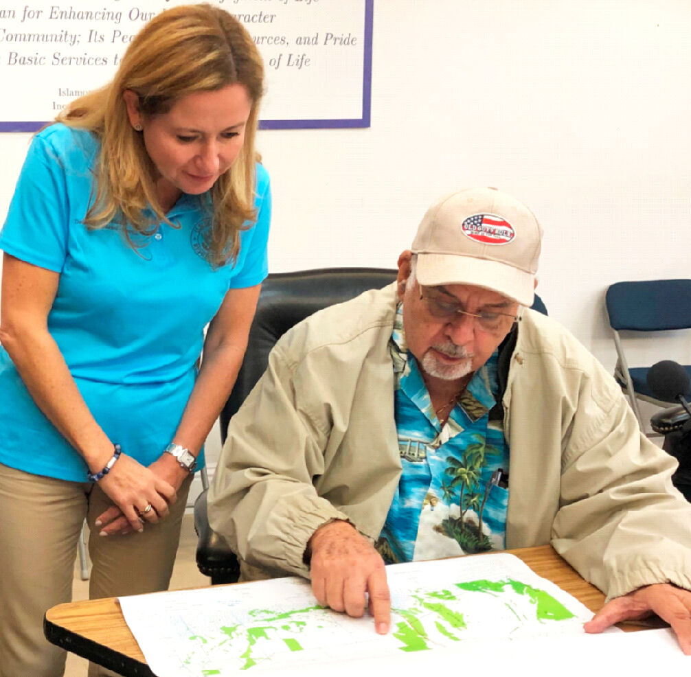 At a late 2019 meeting, Mr. Losner shows Rep. Debbie Mucarsel Powell maps from 1953 and today, illustrating the impeadment of water flow into Flamingo. SDNL